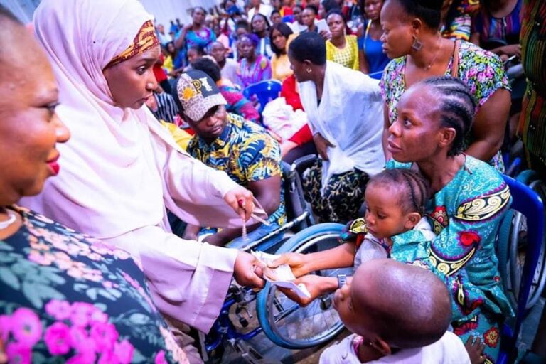 PHOTO NEWS : Minister of  Humanitarian Affairs, Disaster Management and Social Development, Hajiya Sadiya Umar Farouq, handing cash transfer to a beneficiary during the programme flag-off on Thursday, August 4, 2022 in Cross River State.